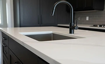 Prefabricated quartz kitchen countertop with integrated undermount sink, showcasing precise cut-to-size fabrication for residential projects