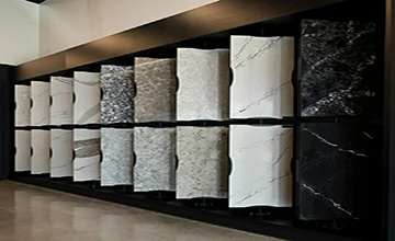 Rotating display of diverse quartz slab colors and textures in a showroom, highlighting the variety of options available