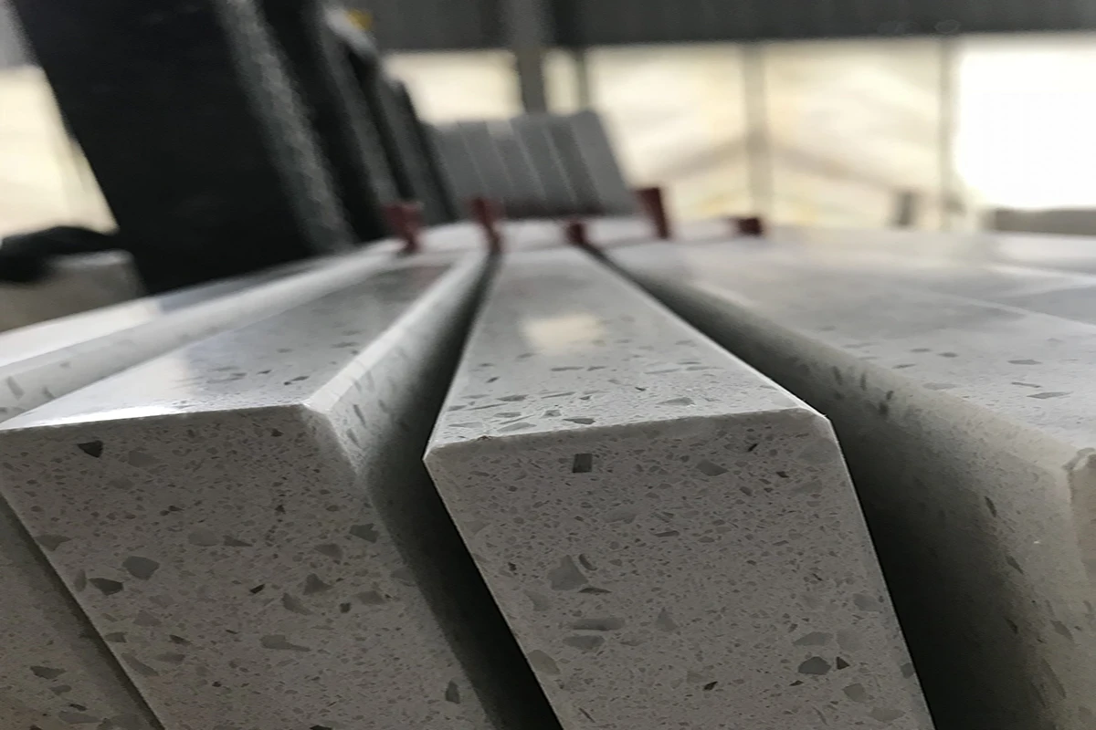 Close-up cross-section of premium AsiaQuartz engineered quartz slabs, showing 2.4 g/cm³ density, natural quartz aggregates, and polished edges for durable, high-performance surfaces