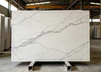 White quartz slab with consistent veining being processed in a factory, showcasing stable resin composition for reliable quality