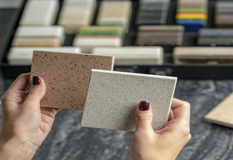Reviewing matched quartz countertop samples for project approval, ensuring the right color and finish for customer projects