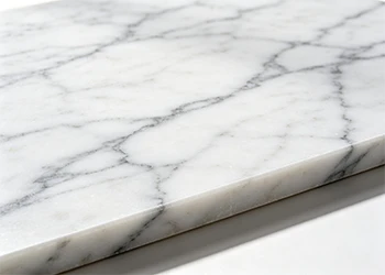 Close-up of polished white quartz slab with grey veining, prepared for material layout and slab production