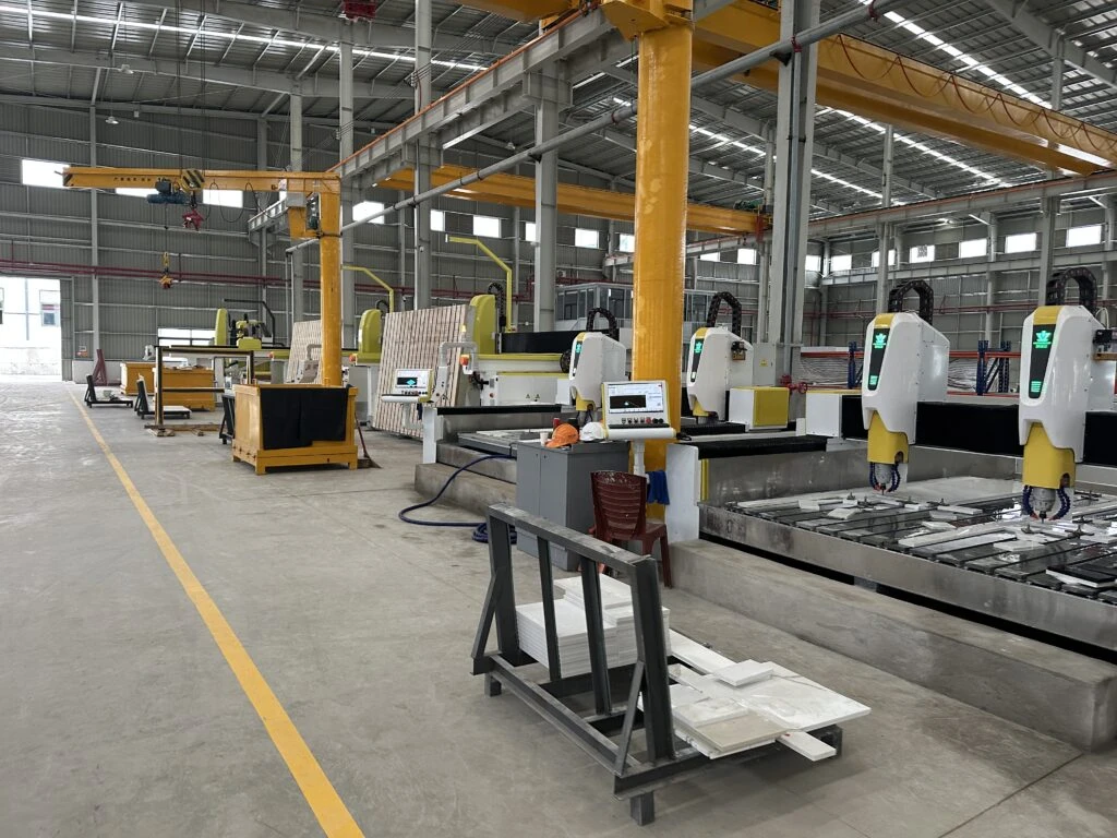 CNC wet-cutting of silica-free engineered stone slab with water suppression and full PPE-safeguarding practices