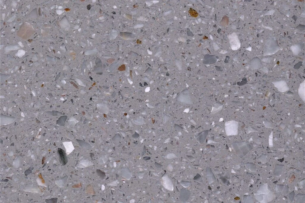 Grigio Royal terrazzo slab by AsiaQuartz - smooth cool light-grey base with milky white, medium grey and amber-brown mineral aggregates for kitchen countertops and wall installations