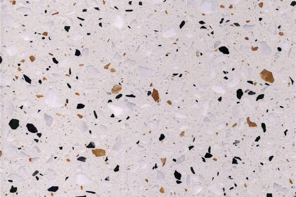 Milky Amber Spot terrazzo slab by AsiaQuartz - milky-white terrazzo matrix with black fragments and warm honey-amber flecks for kitchen countertops and wall cladding