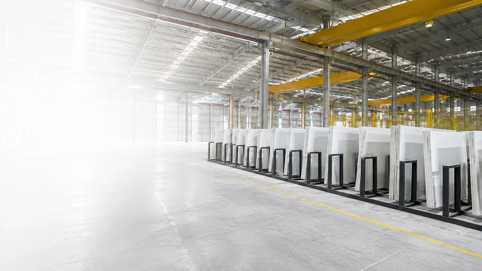 Quartz slab warehouse with organized inventory for wholesale and container supply